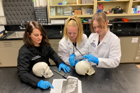 photo of femalte students and skulls