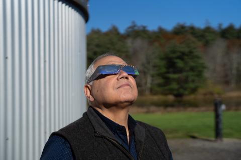 Man wearing eclipse glasses