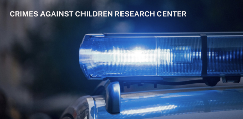 Police car siren lit up blue with the words Crimes against Children Research Center in all caps in white above