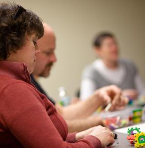 Caregivers sitting at table with blocks