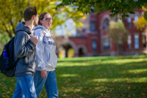 Two students walk through UNH campus