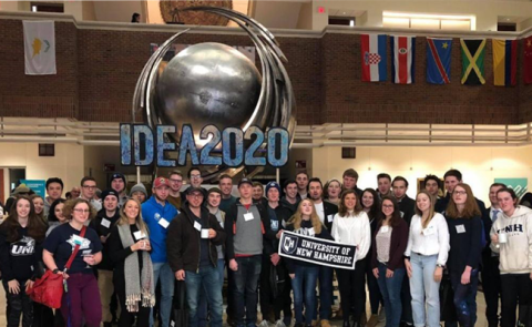 group of students in front of "Idea 2020" statue