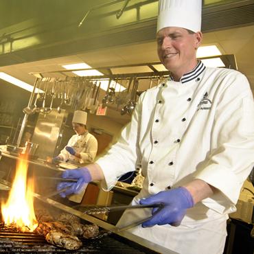 UNH chefs preparing food for event
