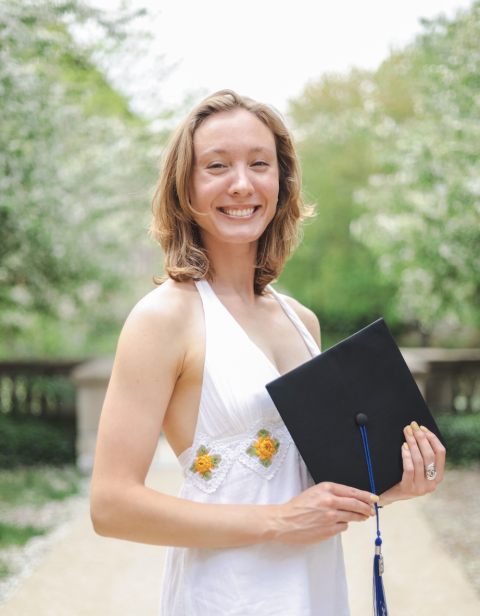 Woman holding graduation cap
