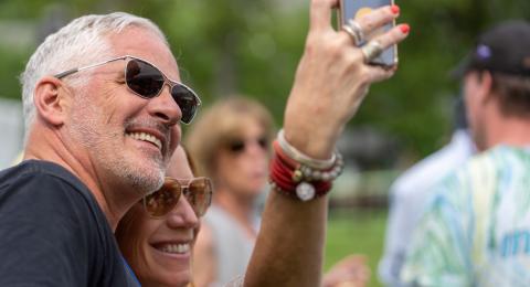 Two alumni taking a selfie at a reunion