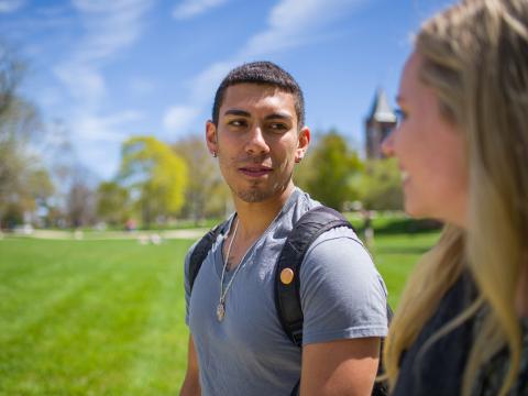 two people talking in front of thompson hall unh