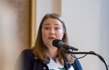 UNH student giving speech in front of podium and microphone