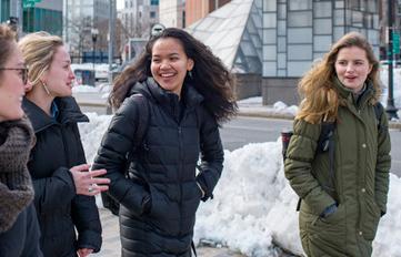 Four UNH Semester In The City students walking outside in downtown Boston