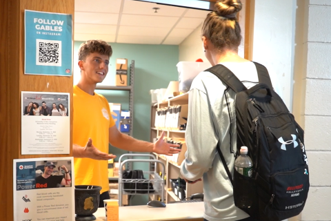 Photo of Gables mailroom with people talking