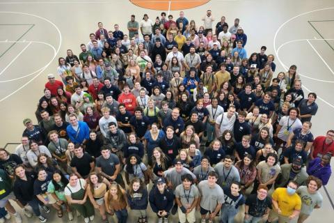 Group photo of RAs and CAs on gym court.