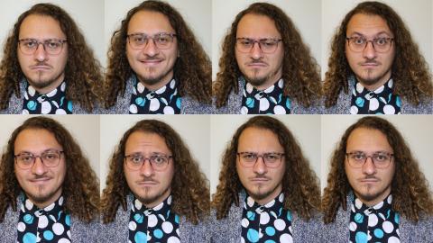 One of the models from the study, with long curly hair, a mustache and goatee, wire rimmed glasses, a blue polka dot shirt and gray cardigan, makes eight different emotion expressions. The photos are combined into two rows of four photos. 