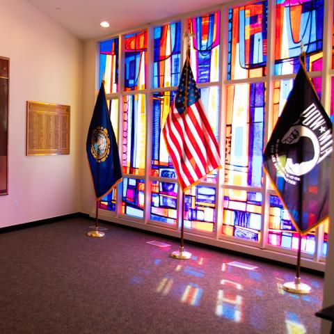 Memorial Room flags in front of stained glass window