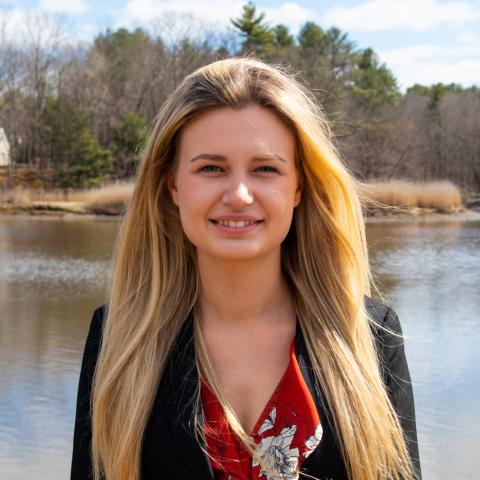 Student standing in front of river