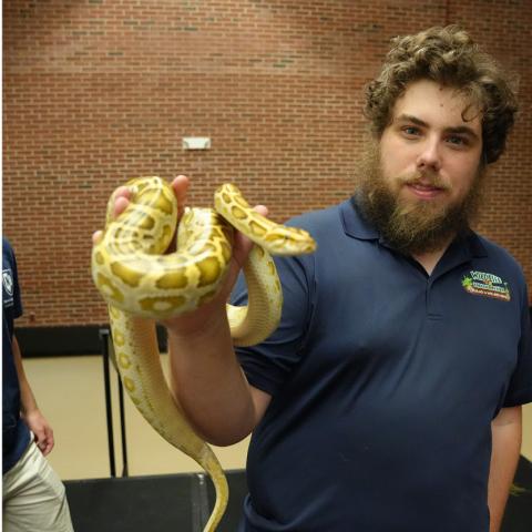 man holding a yellow snake