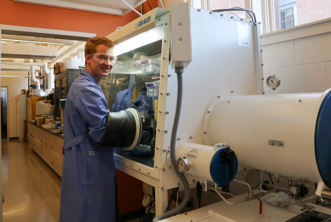 UNH PhD candidate Nick Pollack in front of large research machine