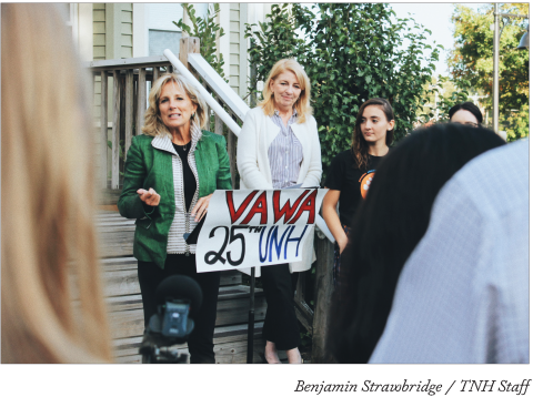 Jill Biden standing in front of SHARPP's building with a sign that reads "VAWA 25th UNH"