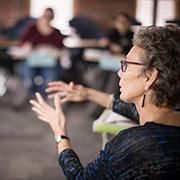 Teacher in a classroom talking with her hands