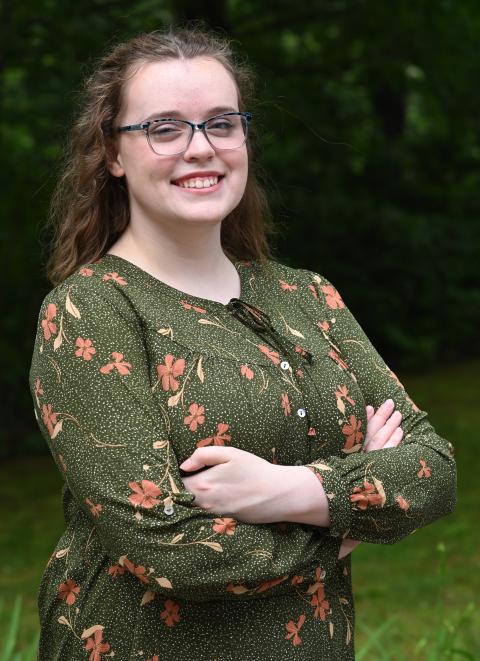 McNair scholar, professionally dressed, wooded backdrop