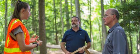 woman talking with two men about forest inventory