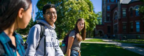 three students walking on campus