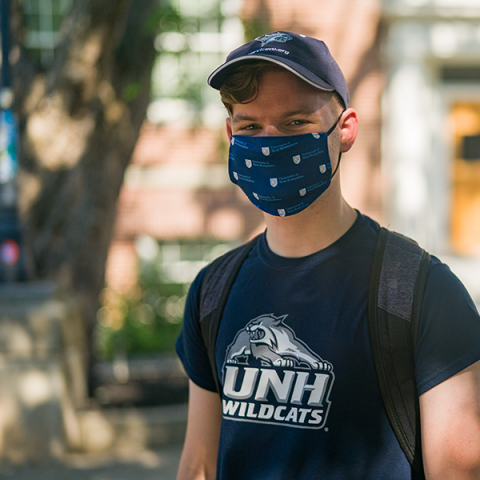 student in UNH branded tee and mask