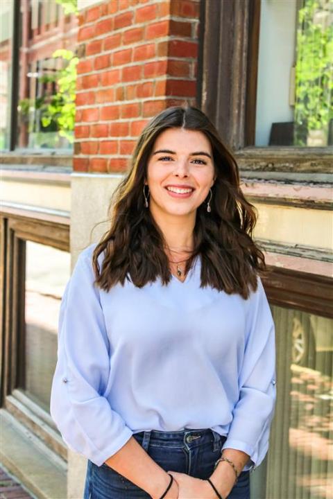 Photo of Daisy Burns in front of a brick building