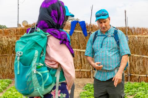 Wilner talking with people on a Senegalese farm