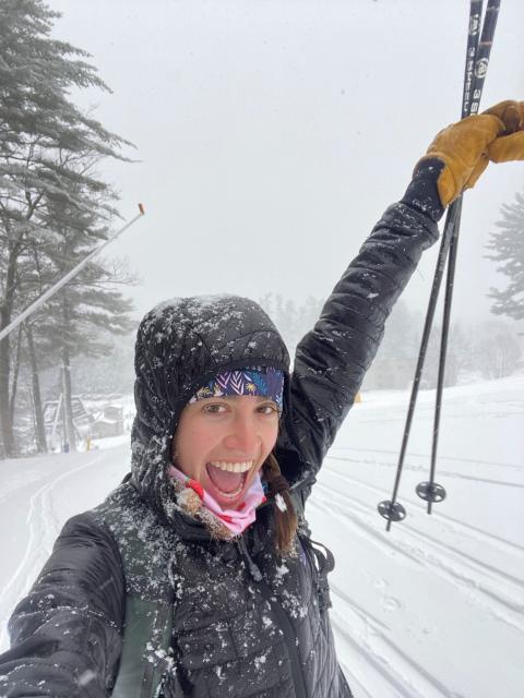 person taking a selfie in the snow holding ski poles