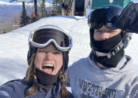 two people in ski helmets and goggles in the winter