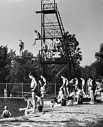 Vintage photo of old UNH Pool Diving Tower at old outdoor pool; swimmers.