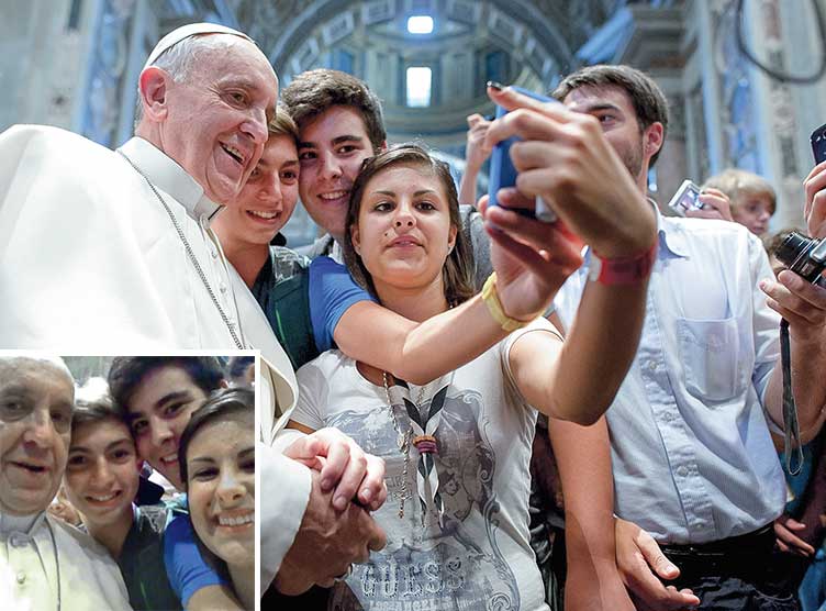 Pope Francis posing for a selfie with teenagers
