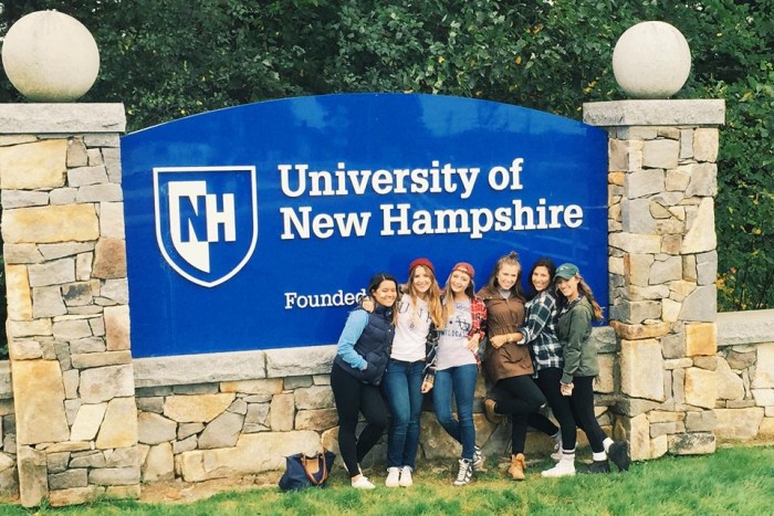 Allison Bellucci with other UNH students in front of the UNH sign