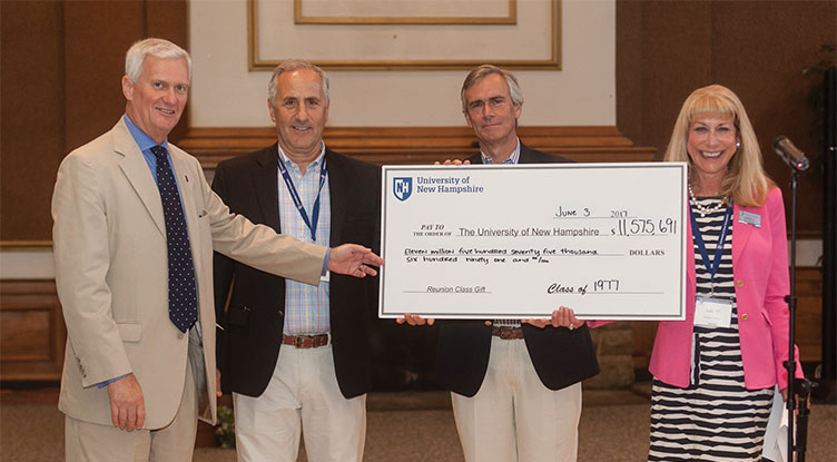 UNH President Mark Huddleston and members of the class of 1977 with their reunion class gift check for UNH