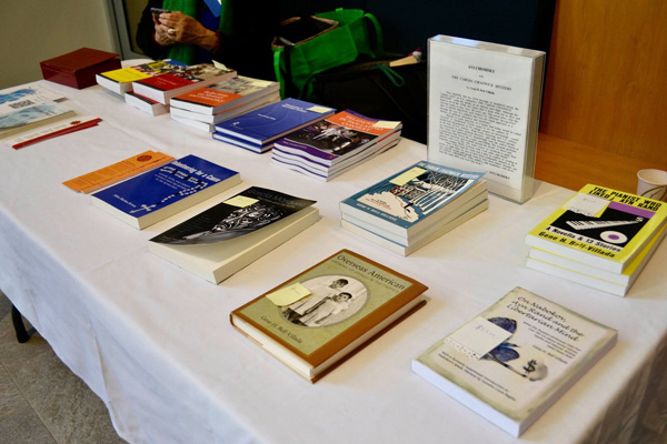 NECLAS table with books