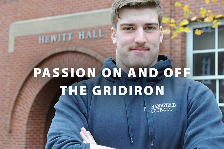 UNH student Jeff Carter '19 in front of Hewitt Hall