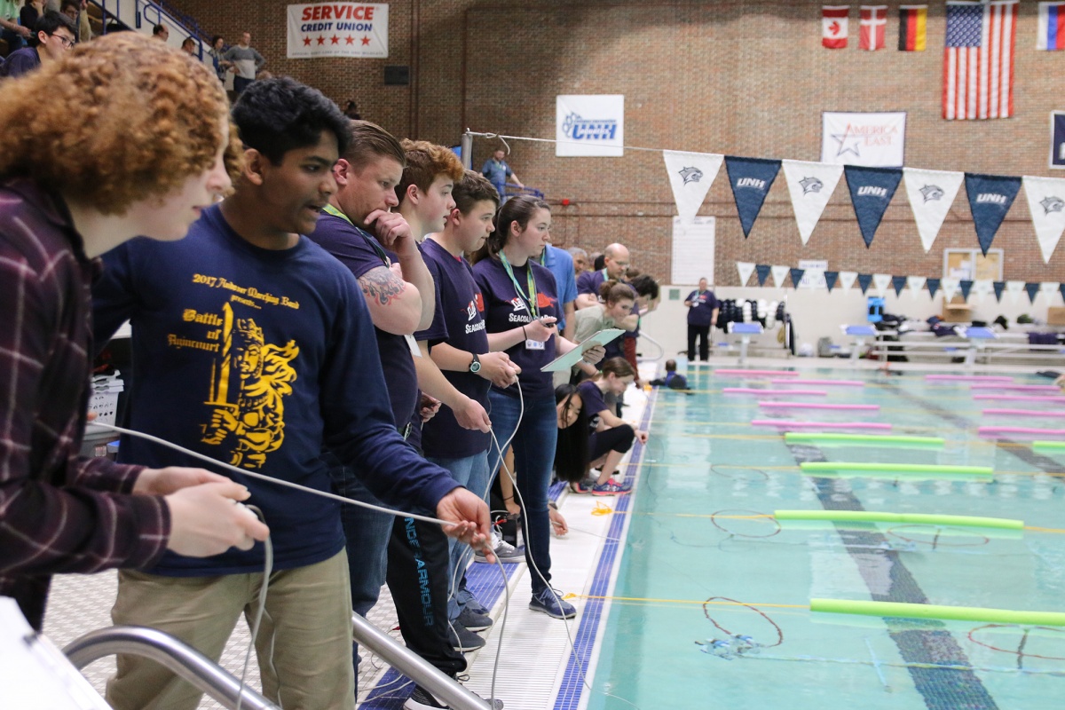 Middle school students testing their underwater robots at the UNH pool during SeaPerch challenge