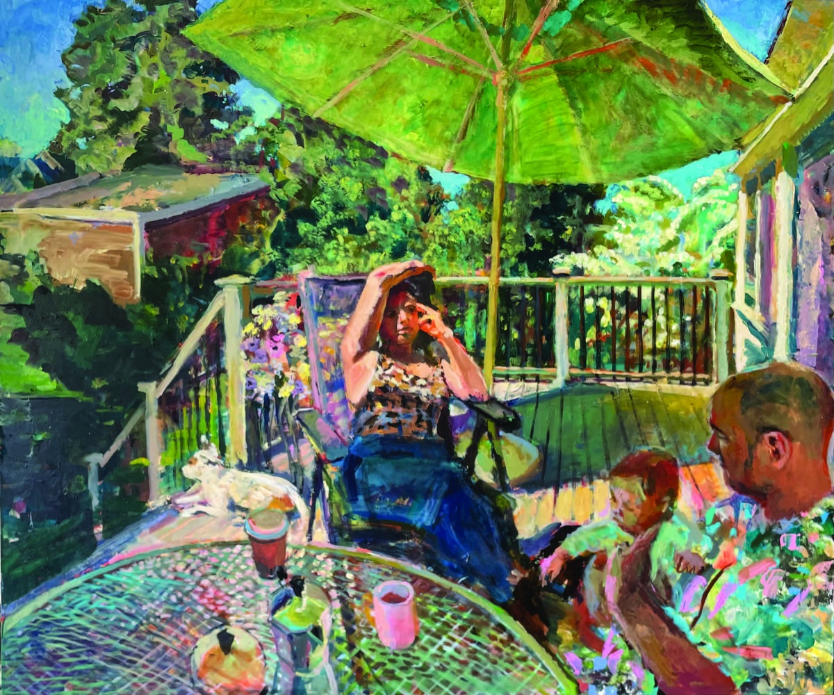 family sitting at table on a deck