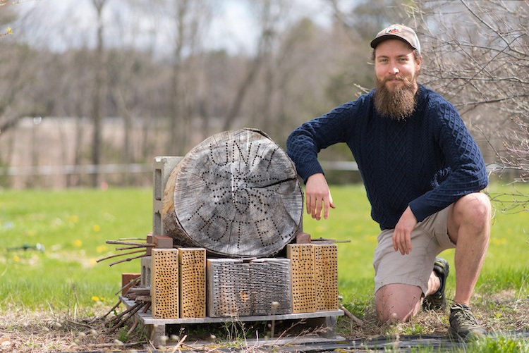 ​Grad student Wyatt Shell with bee hotel he built​