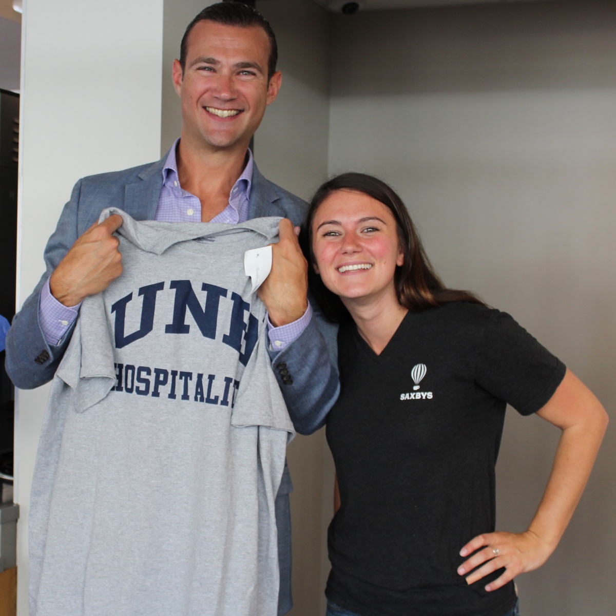 Crowe with Saxbys CEO Nick Bayer after gifting him with a UNH Hospitality T-shirt