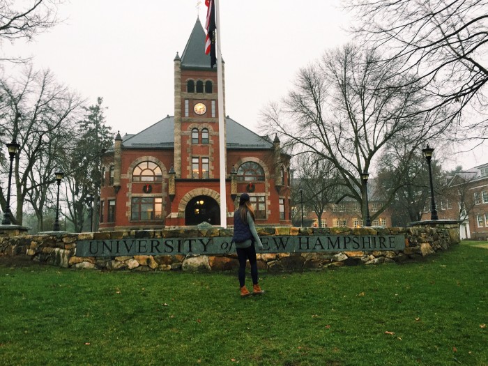 UNH student Charlotte Harris '18 in front of Thompson Hall