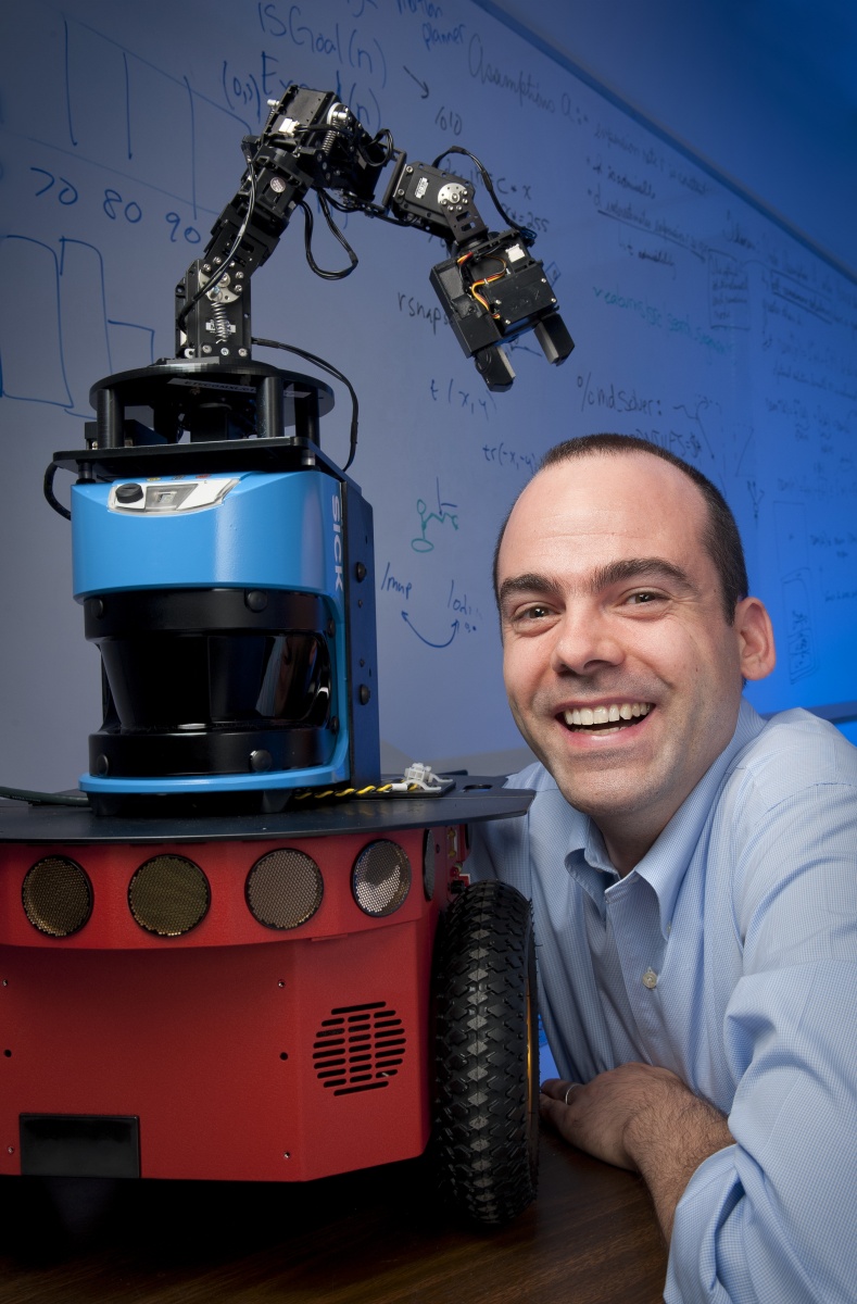 Professor Wheeler Ruml beside a robot
