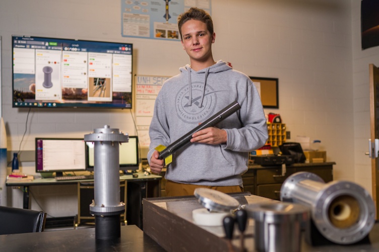 Charlie Nitschelm ’20 in a lab with parts of a rocket he's made.