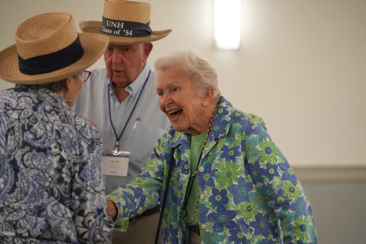 Older alums greeting each other at reunion