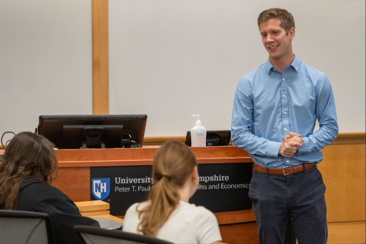 Steve Irlbeck in front of a Paul College speaking with students.