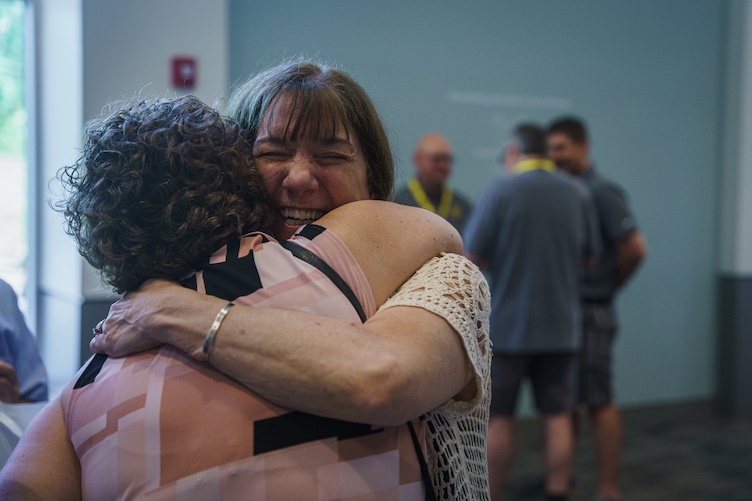 Friends embrace in a hug during reunion