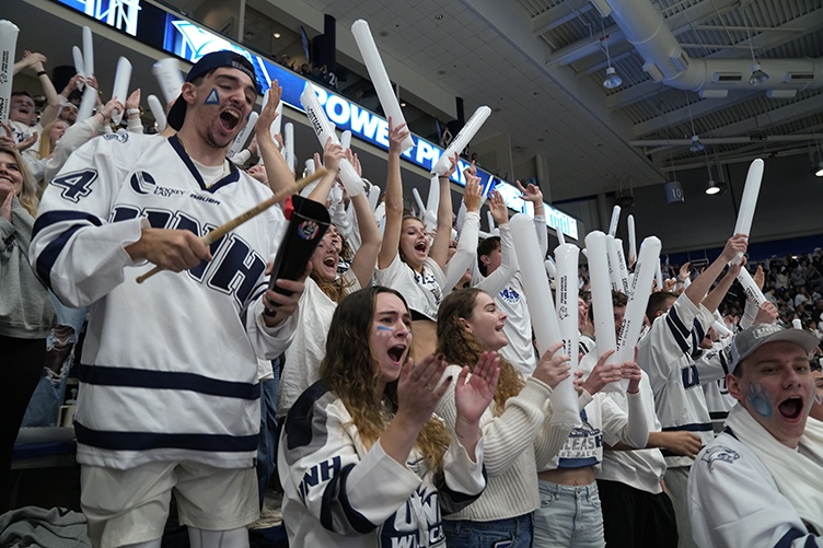 Close up shot of cheering fans at a hockey game