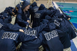 women's swimming team, huddled before a competition