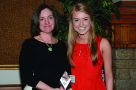 Christine Carberry '82 and Megan Cooley '17 pose for a photo with an award.