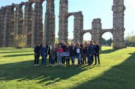 Charlotte Harris '18 and other UNH students in front of an aqueduct in Spain