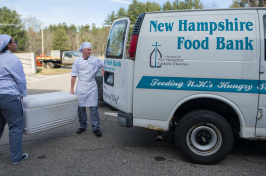 UNH-grown fish in a cooler being handed to the NH Food Bank
